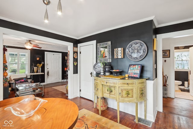 dining space featuring ceiling fan, dark hardwood / wood-style floors, and crown molding