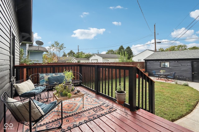 wooden deck with an outbuilding and a yard