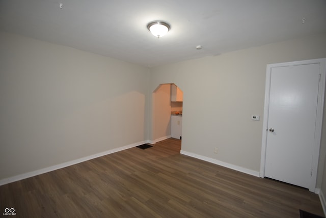 empty room with dark hardwood / wood-style floors