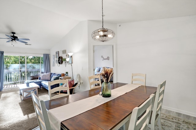 carpeted dining room with ceiling fan and lofted ceiling