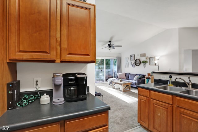 6517 Emerald Hill Ct Apt 312, Indianapolis, IN 46237 - kitchen featuring vaulted ceiling, light carpet, dark countertops, ceiling fan, and a sink