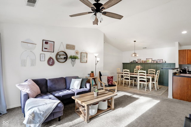 living room with light carpet, lofted ceiling, and ceiling fan