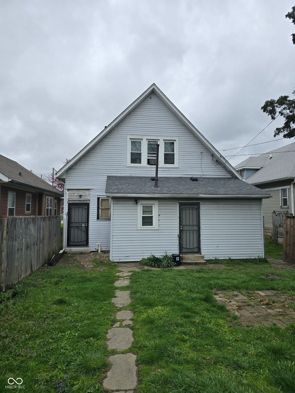 rear view of house with a lawn