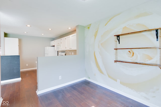 unfurnished room featuring dark hardwood / wood-style floors and sink