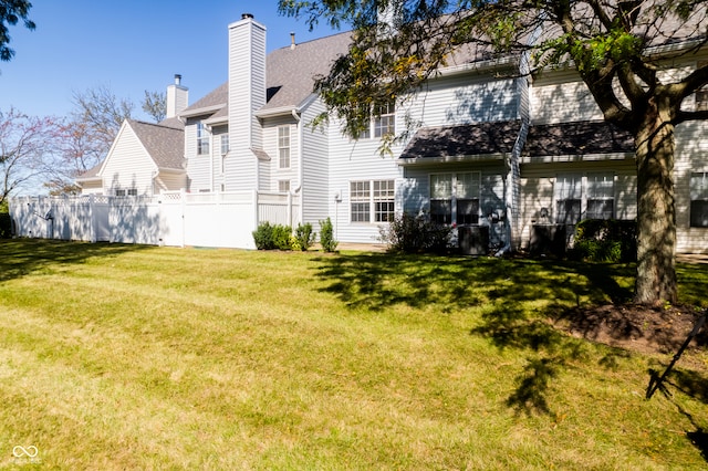 rear view of property with a lawn