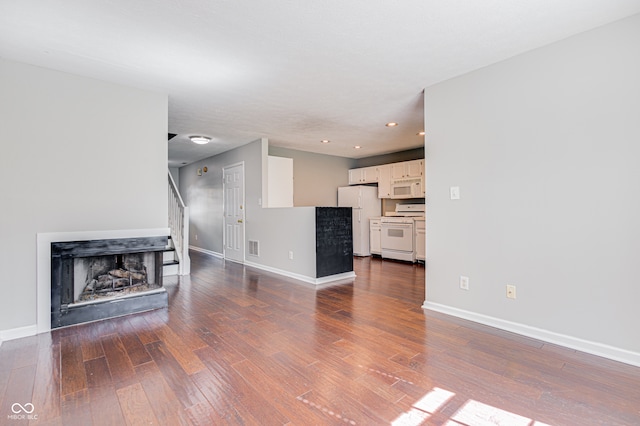 unfurnished living room with wood-type flooring