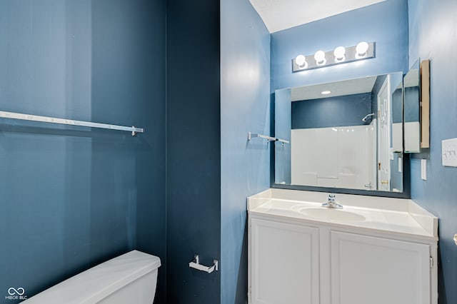 bathroom with vanity, toilet, and walk in shower