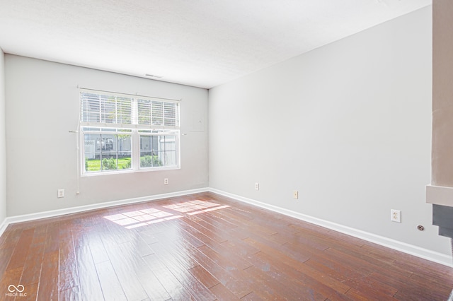 spare room with hardwood / wood-style flooring and a textured ceiling