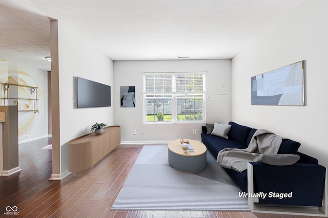 living room featuring hardwood / wood-style floors and a textured ceiling