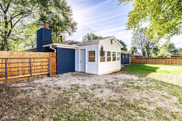 rear view of house with a yard