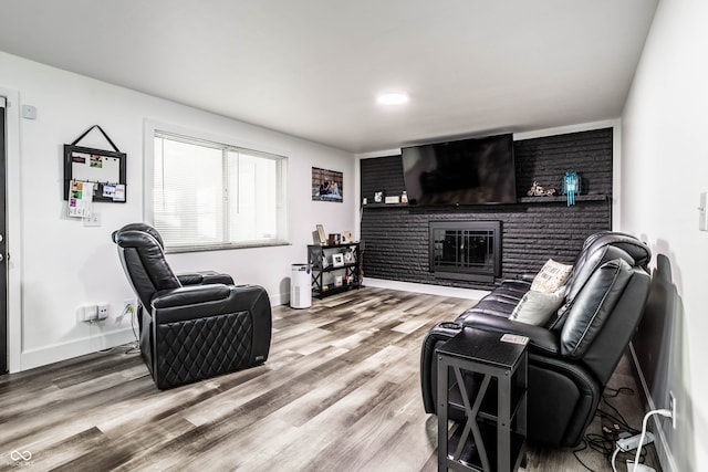 living room with hardwood / wood-style flooring and a fireplace