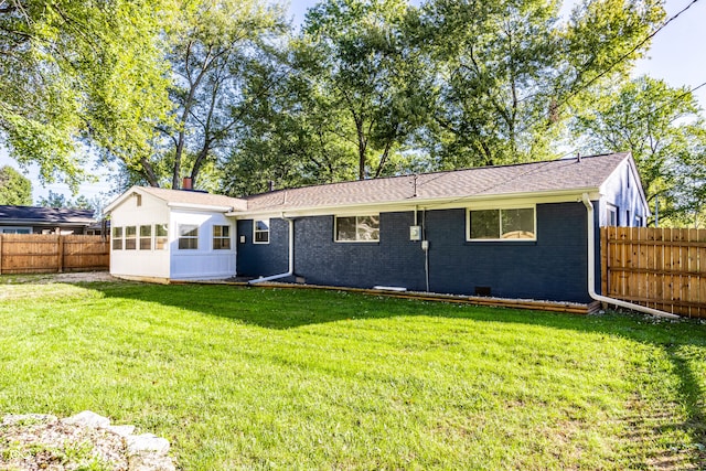 back of house featuring a yard