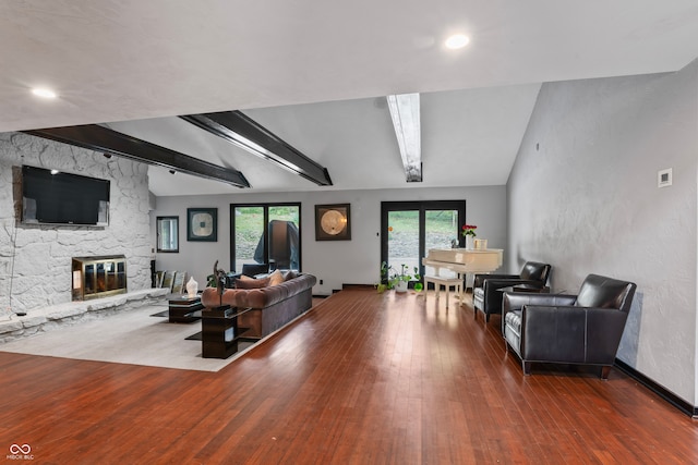 living room with a fireplace, lofted ceiling with beams, and dark hardwood / wood-style flooring