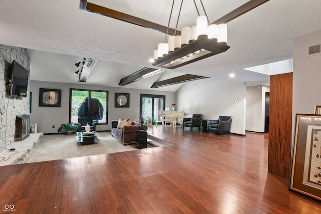 living room with lofted ceiling with beams and hardwood / wood-style flooring