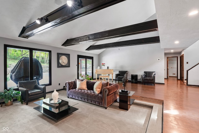 living room with light hardwood / wood-style flooring and lofted ceiling with beams