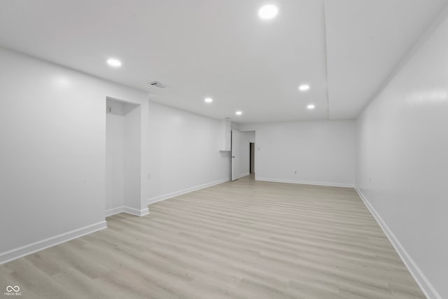 basement with light hardwood / wood-style floors