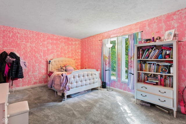 bedroom with multiple windows, a textured ceiling, and carpet flooring