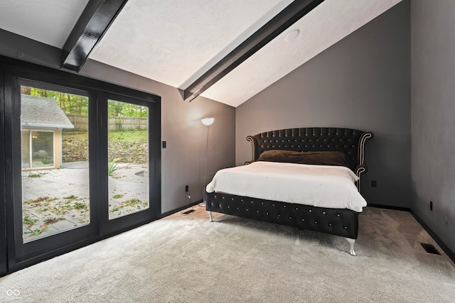 bedroom with lofted ceiling with beams and carpet flooring