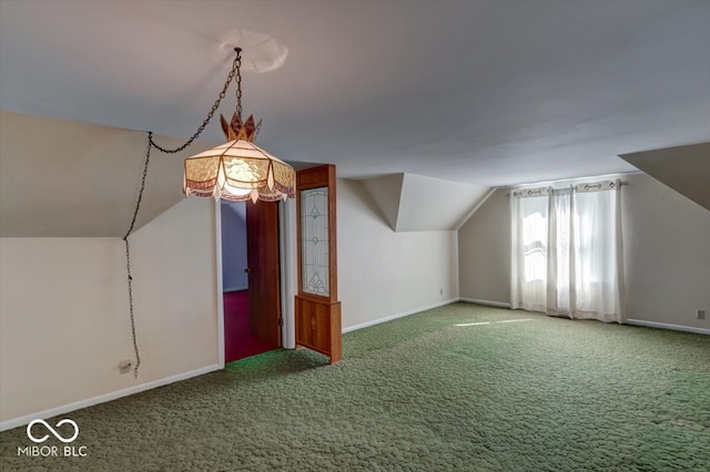 bonus room with vaulted ceiling and carpet