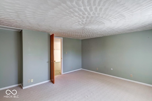 interior space with a textured ceiling and light colored carpet