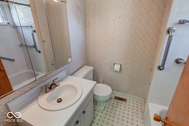 full bathroom with tiled shower / bath combo, vanity, and toilet