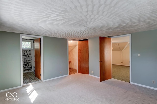 basement with a textured ceiling and light colored carpet