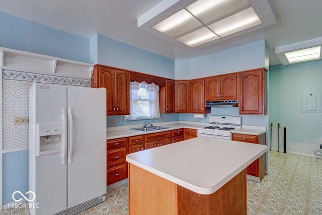 kitchen with white appliances, a center island, and sink