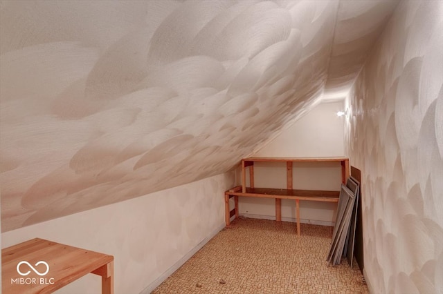 bonus room featuring lofted ceiling and light colored carpet