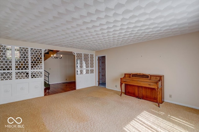 interior space with a chandelier and carpet flooring