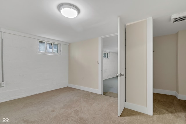 basement featuring light carpet