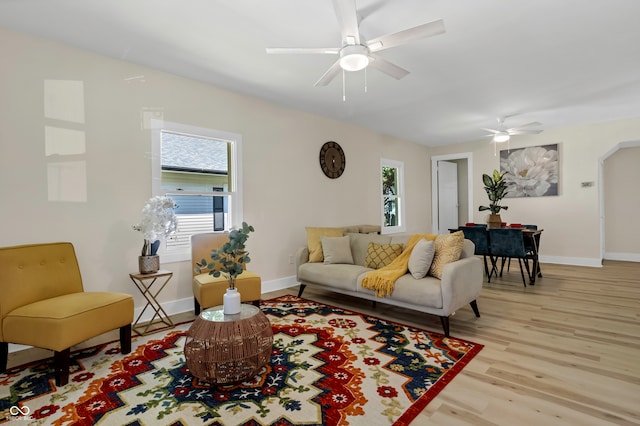 living room featuring light hardwood / wood-style floors and ceiling fan