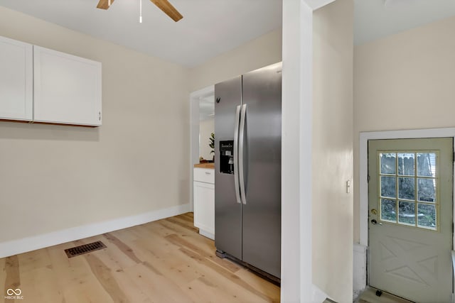 kitchen featuring light wood-type flooring, white cabinets, stainless steel refrigerator with ice dispenser, wooden counters, and ceiling fan