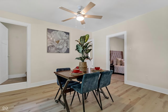 dining area with light hardwood / wood-style floors and ceiling fan