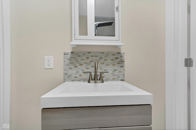 bathroom with sink and tasteful backsplash