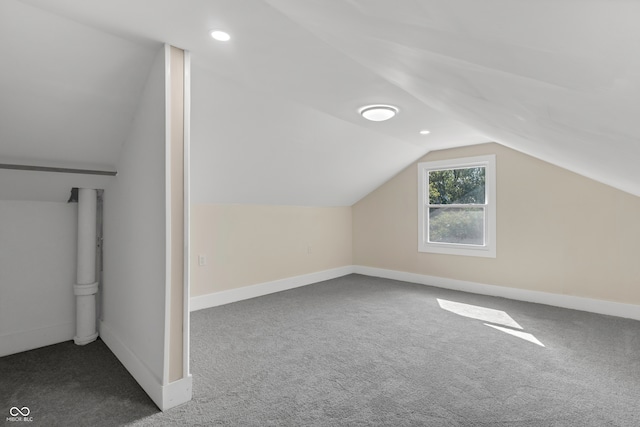 additional living space featuring lofted ceiling and carpet