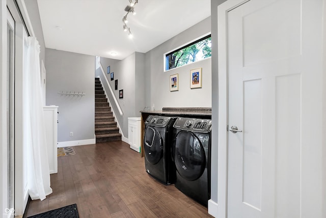 laundry area featuring cabinet space, baseboards, dark wood-type flooring, washer and dryer, and track lighting