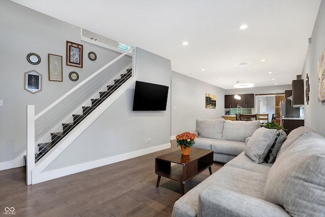 living area with stairs, baseboards, dark wood-type flooring, and recessed lighting