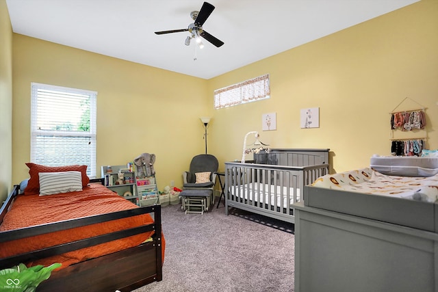 carpeted bedroom featuring ceiling fan and multiple windows