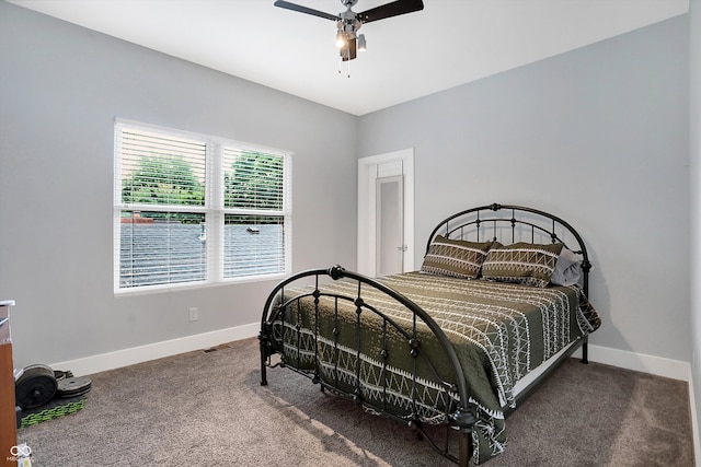 carpeted bedroom with a ceiling fan and baseboards