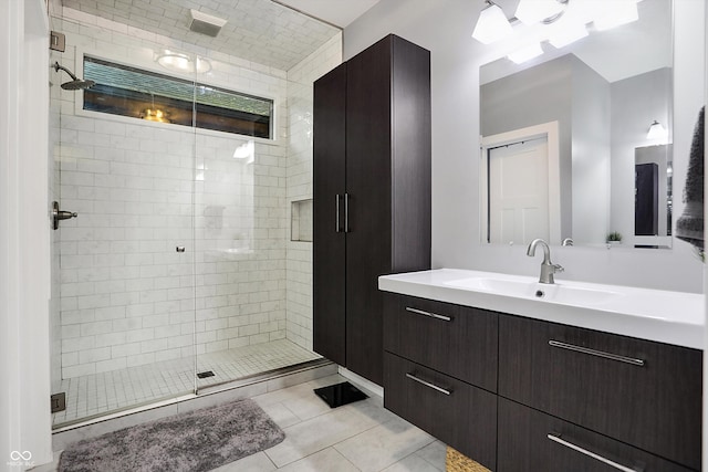 bathroom featuring a stall shower, tile patterned flooring, and vanity