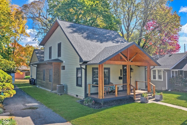 bungalow-style home with covered porch, a front yard, and central AC