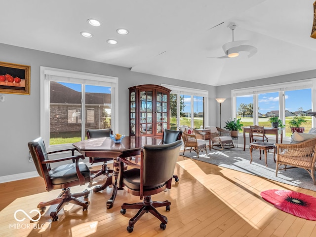 dining room with a wealth of natural light, lofted ceiling, and light hardwood / wood-style floors