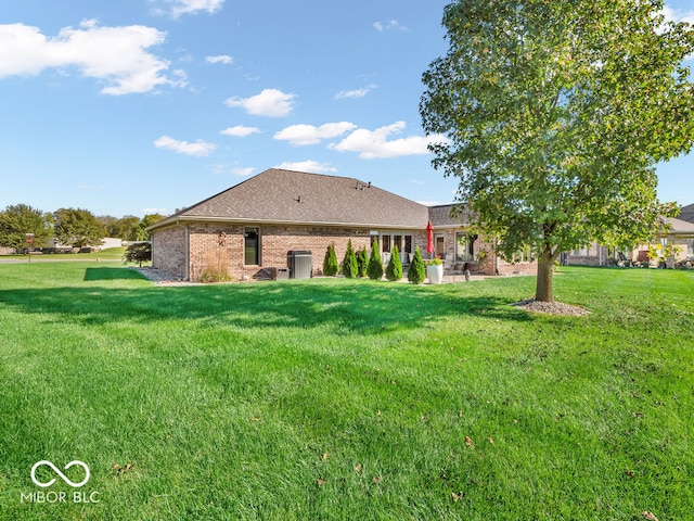 back of house with a lawn and a patio