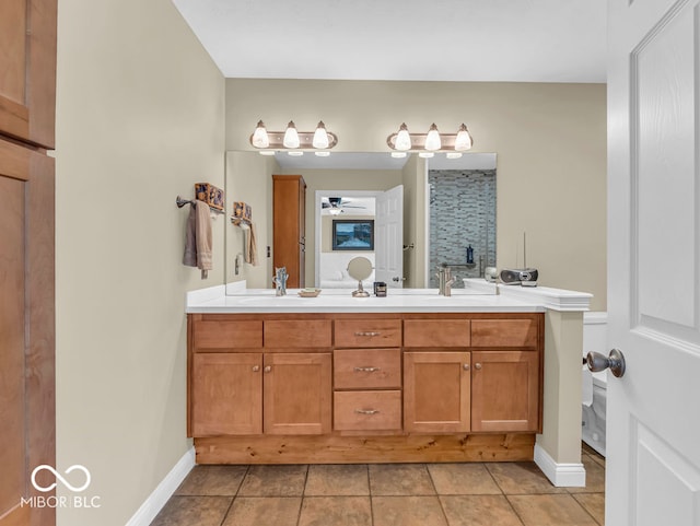 bathroom with tile patterned floors, ceiling fan, and vanity