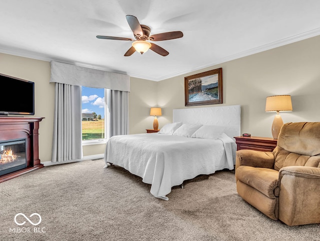 carpeted bedroom with ceiling fan and crown molding