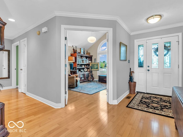 entrance foyer featuring crown molding and light hardwood / wood-style floors