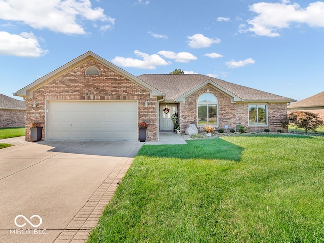 ranch-style house featuring a garage and a front lawn