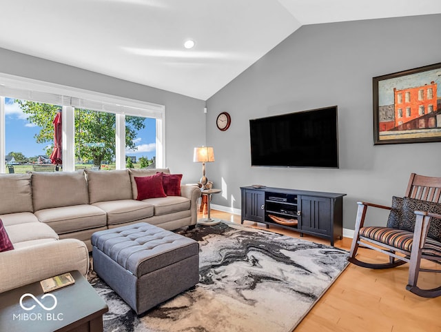 living room featuring vaulted ceiling and hardwood / wood-style flooring