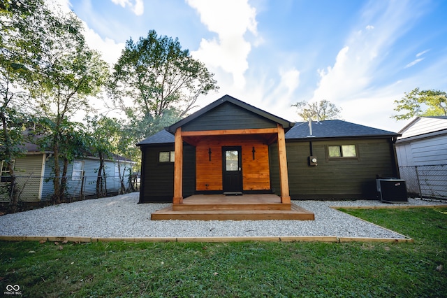 back of property with a lawn and central air condition unit