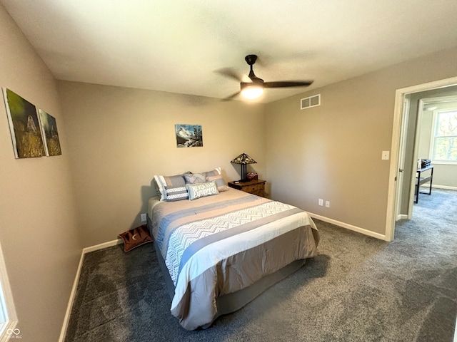 bedroom with ceiling fan and dark carpet